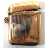 A 9ct gold vesta case Decorated with an engraved linear design, with match striker to the base,