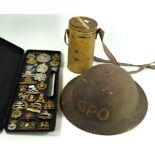 A WWII British GPO helmet A tin cased WWII period gas mask,