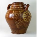 18th century slip-ware vessel of tapering bulbous form Decorated with a stylised sun and motifs,