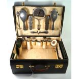 A ladies leather travelling case early 20th Century The interior fitted out with silver backed