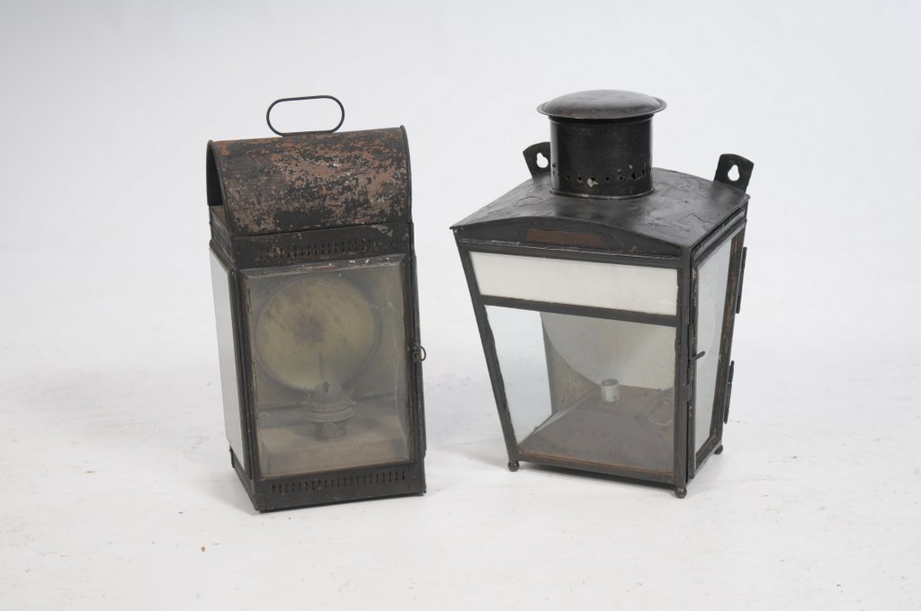 A Victorian black painted station lamp Of rectangular form, glass panelled sides, a pierced gallery,