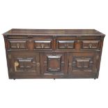 A 19th Century oak Jacobean style sideboard The rectangular moulded plank top above a pair of