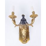 A French Empire style two branch wall light The scalloped panel back,