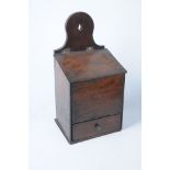 A 19th Century oak hanging candle box The arched upper bracket extending to a sloped front,