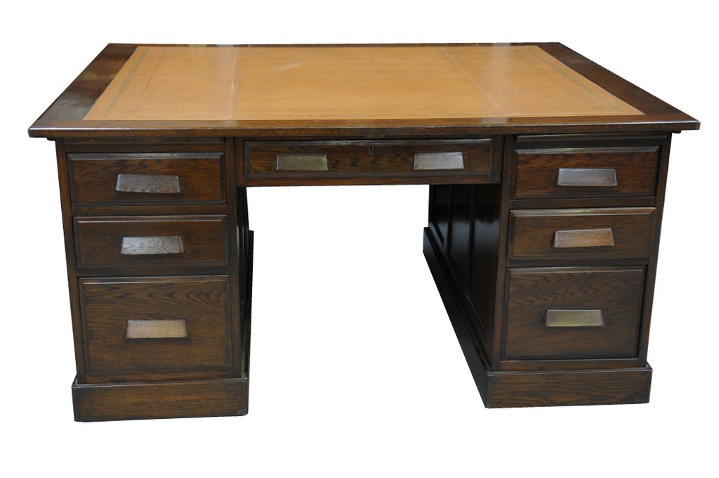 An early 20th Century oak partners desk The rectangular top inset with a tan leather and a gilt