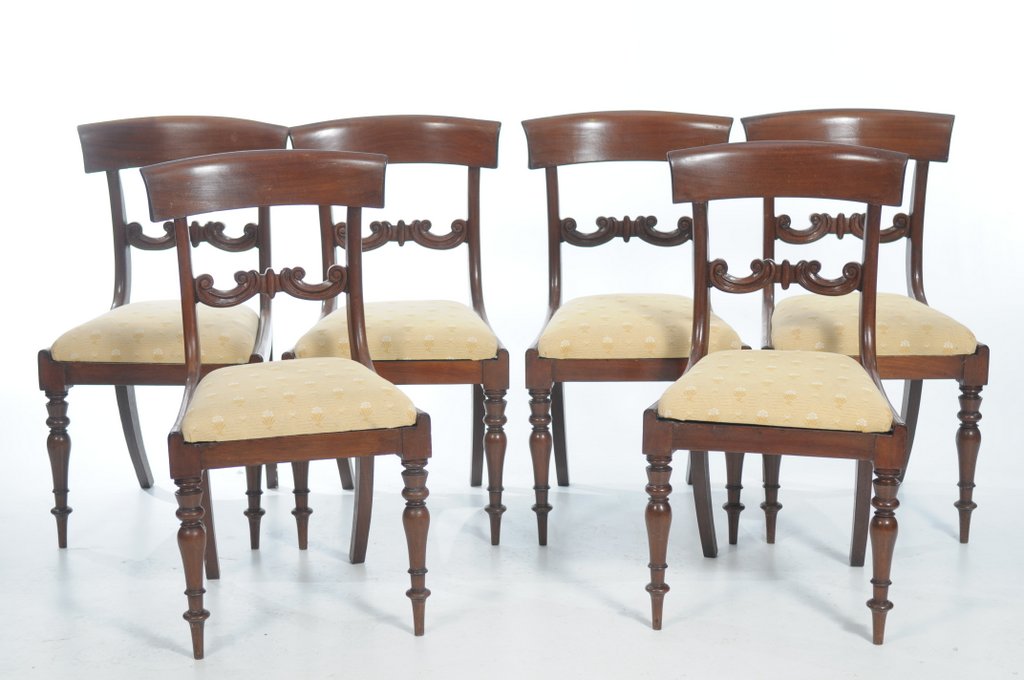 A set of six mid 19th Century mahogany dining chairs The concave crest rails above a channelled and