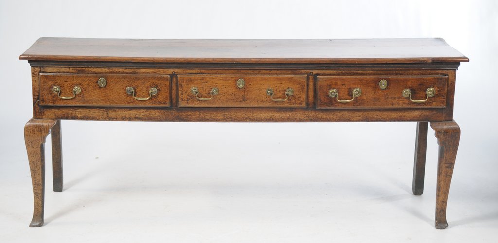 A George III oak dresser base The two plank rectangular top above three short drawers fitted with