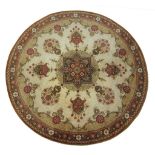 A Peshawar style rug Of circular form, with a predominantly ochre and gold ground,