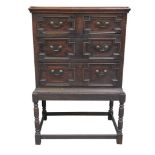 A 19th Century oak Jacobean style chest on stand The rectangular top above an arrangement of two