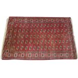 A Bokhara rug of typical rectangular form with central repeating geometric medallion design set
