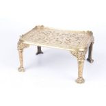 A Victorian small cast brass footman or trivet The rectangular top cast with central rosette