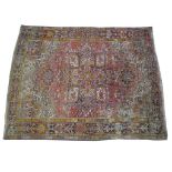 A Persian medallion rug The large rectangular rug on a predominantly pink ground,