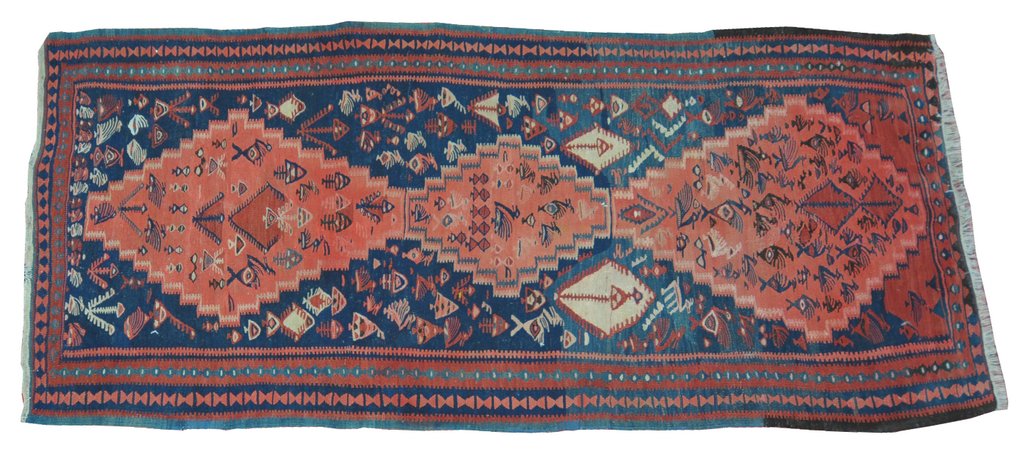 A Kazak style medallion runner Of typical form, with a predominantly navy blue ground,