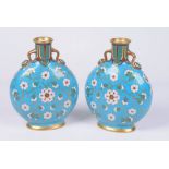 A pair of English porcelain Moonflasks, possibly Minton, Circa 1880 Each of flattened circular form,