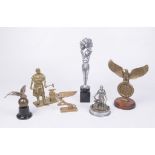 A collection of six cast brass hood ornaments Each of varying form,