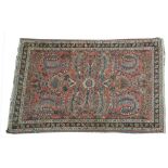 A Kazak style rug The predominantly faded red ground,