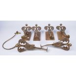 A set of six cast and polished metal curtain tie backs,