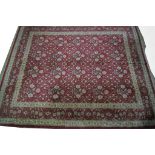 A modern Bokhara style carpet The large rectangular carpet to a predominantly ruby red ground,