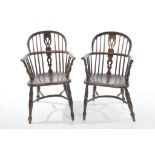 A near pair of 19th Century elm Windsor elbow chairs Each with a hooped back and a central pierced