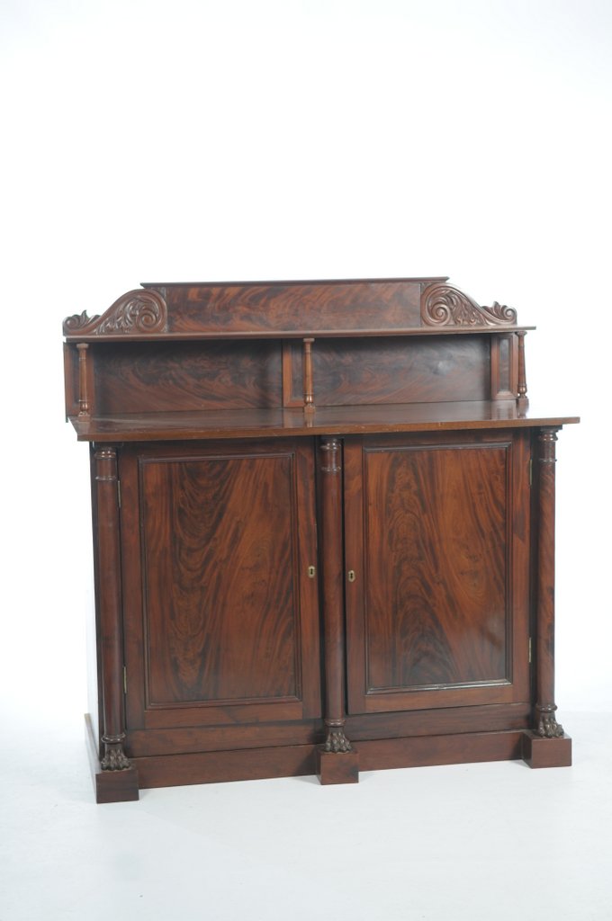 A Regency mahogany sideboard The raised back with a shelf supported by three ring turned tapering