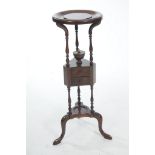 A 19th Century mahogany wig stand The circular top supported on three ring turned and baluster