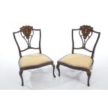 A pair of Edwardian mahogany low seat chairs,
