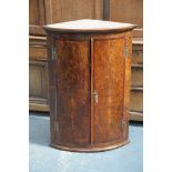 An unusual late 18th Century pollard oak bowfront hanging corner cupboard,