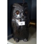 An early 20th Century Black Forest carved wooden jar and cover in the form of an owl, approx 26cm.