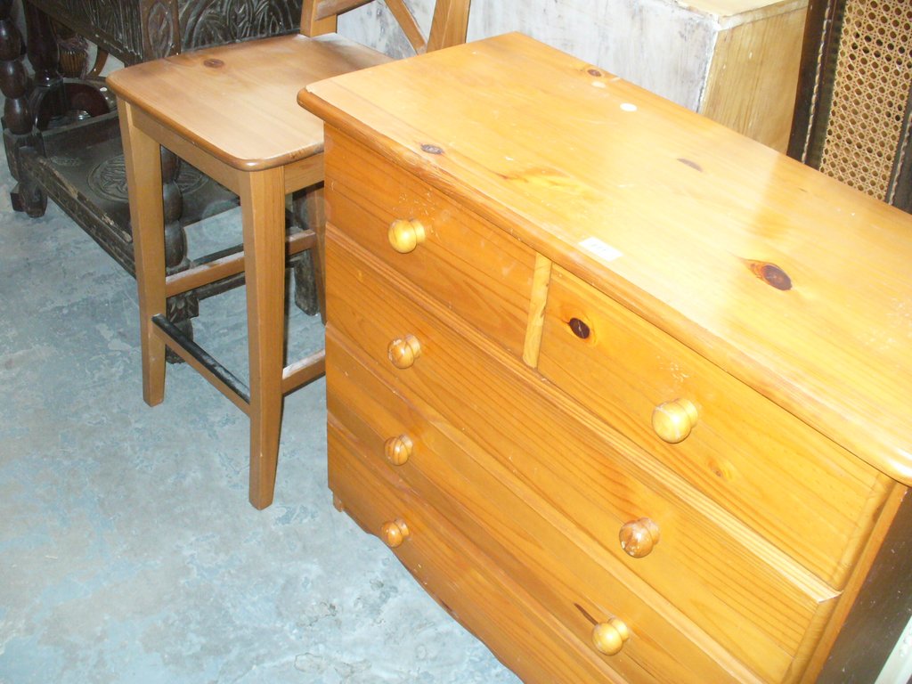 A modern pine chest of two short and three long drawers and a pine bar stool.