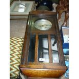 An Early 20th Century oak cased wall clock, silvered dial.