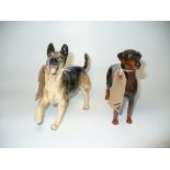 A Royal Doulton model of an Alsatian and a Beswick model of a Doberman.