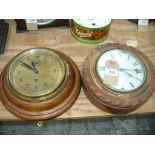 An Oak cased rope border wall clock and a second similar clock.