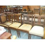 A Set of six late Victorian oak dining chairs with a Greek key pattern moulded rail.