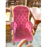 A Victorian mahogany button back drawing room chair with padded arms,