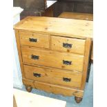 A pine chest of drawers, two short and two long drawers raised on vase shaped front feet.