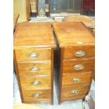 A Pair of early 20th Century walnut four drawer pedestal chests,