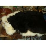 Seven assorted sheepskin rugs.