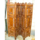 An Eastern hardwood and brass inlaid carved open work three fold room screen.