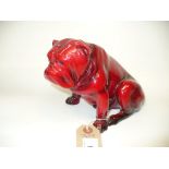 A Royal Doulton flambe model of a seated bulldog.