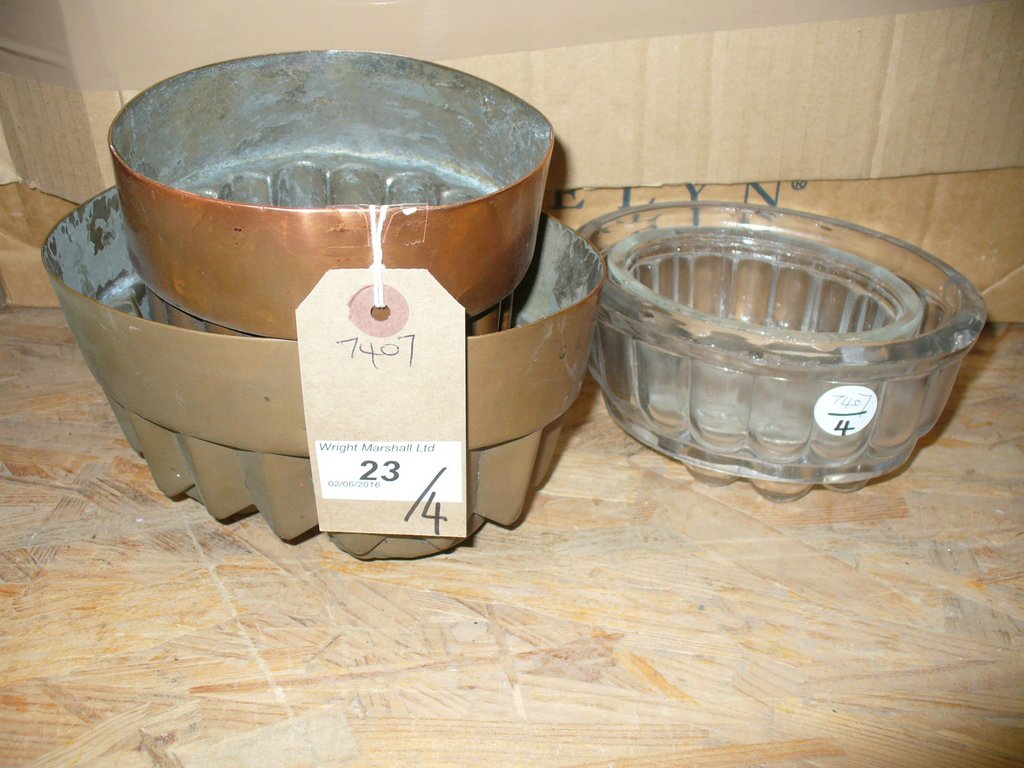 Two Vintage copper jelly moulds including a fox mask example and two glass jelly moulds.