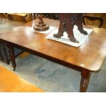 A 19th Century mahogany extending dining table raised on ring turned legs and castors.