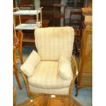An Ercol light elm easy chair with loose cushions.