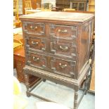 A 19th Century oak Jacobean style chest on stand The rectangular top above an arrangement of two