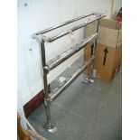 A Chromed tubular freestanding heated towel rail.