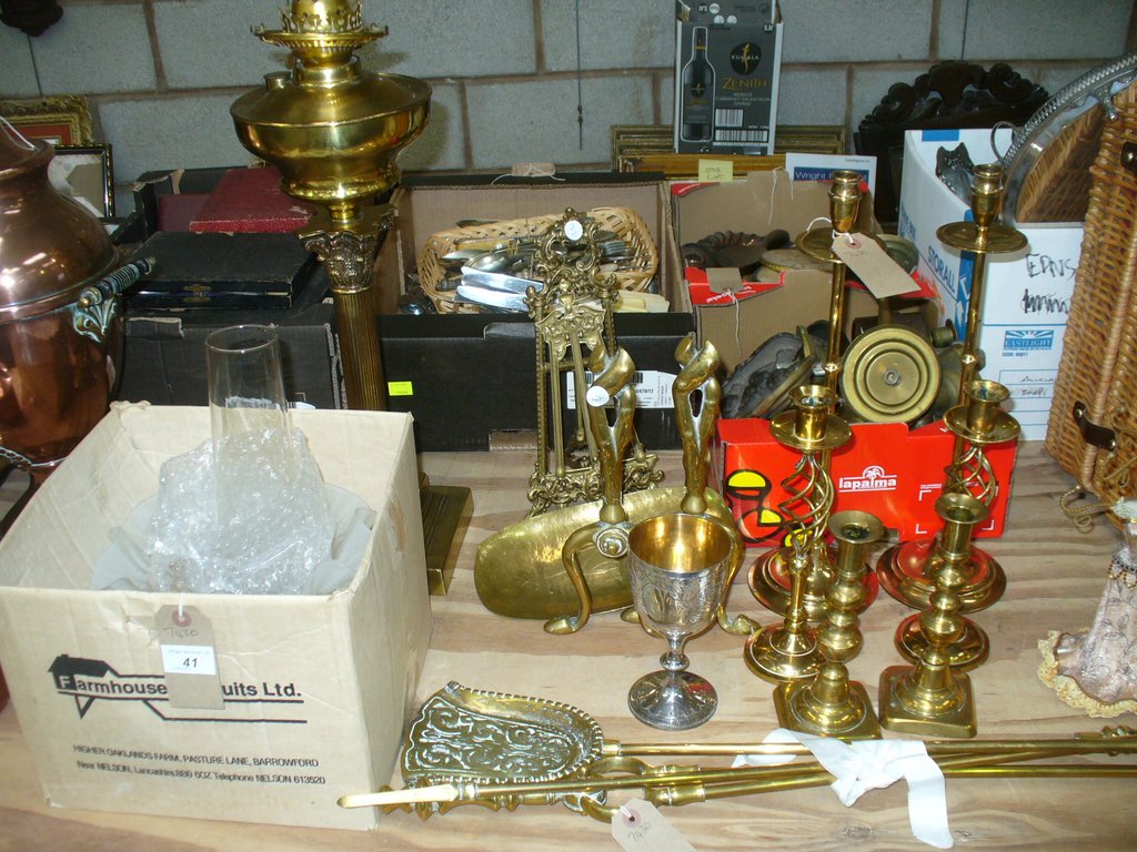 A Victorian brass column oil lamp, two gilt metal easel frames, a pair of brass fire dogs,