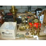 A Victorian brass column oil lamp, two gilt metal easel frames, a pair of brass fire dogs,