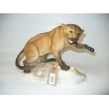 A Beswick model of a matt tawny puma on a base in the form of a rocky outcrop, model no.
