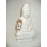 A Chinese white quartz carved figure of Guayin seated in meditation raised on a lotus base