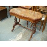 A Victorian burr walnut serpentine folding games table raised on two baluster leaf carved supports