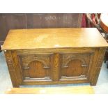 A Reproduction oak blanket chest with two inverted moulded panels.